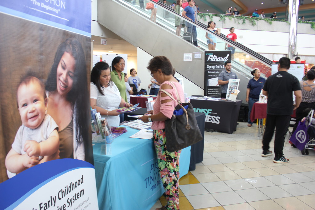 Photo of Terry Naputi, Guam CEDDERS Research Associate, sharing resources at an outreach event.
