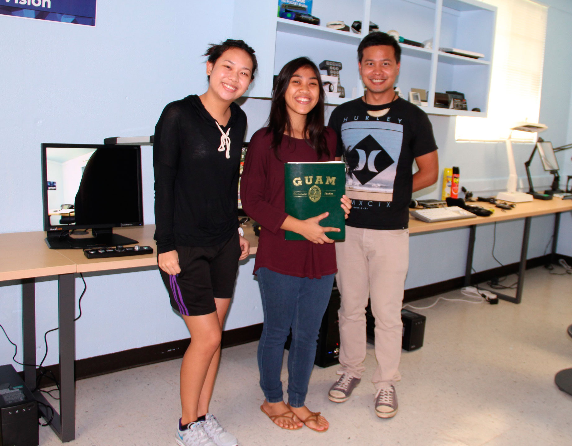 Three students in assistive technology center.