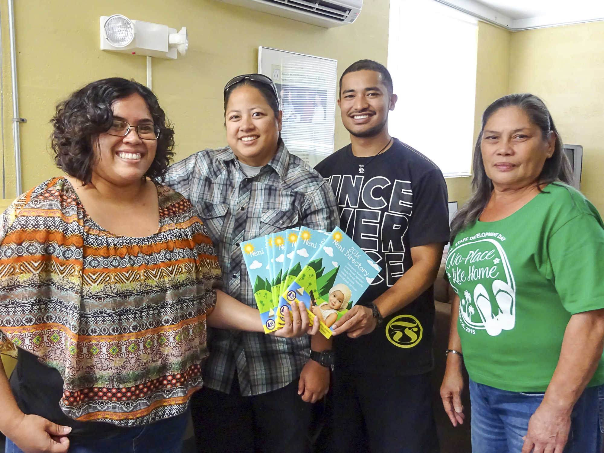 Representatives receiving the 2016 Neni Directory from Guam CEDDERS.