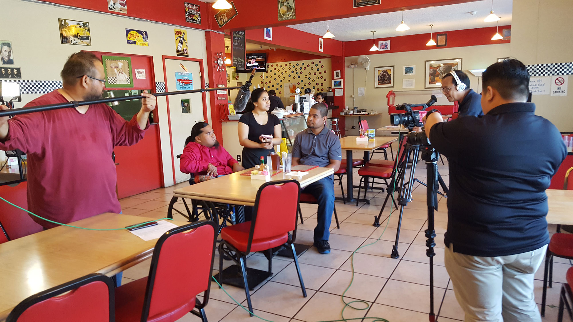PBS Guam and Ron’s Diner assisted in filming scenes for “Ta Fan Acomprendi: Communicating with People with Disabilities,” on June 8.  Pictured at the table from left to right: Moses Puas, Self-Advocate; Christina Cabrera, Ron’s Diner Representative; and Wansesty Yalismwar, Personal Care Attendant.