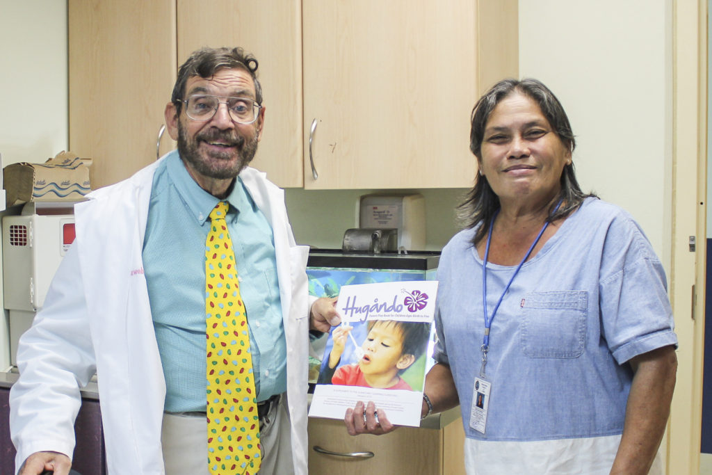 On August 8, Ruth Leon Guerrero, Guam CEDDERS staff, presented 50 copies of the Hugåndo (Play) Book to Lee Meadows, M.D., physician at the Northern Region Community Health Center in Dededo.  The Hugåndo book provides suggestions for parents and child caregivers on ways to promote learning with young children.  This resource is available in English, Filipino, and Chuukese and will be passed out to patients who visit the NRCHC.