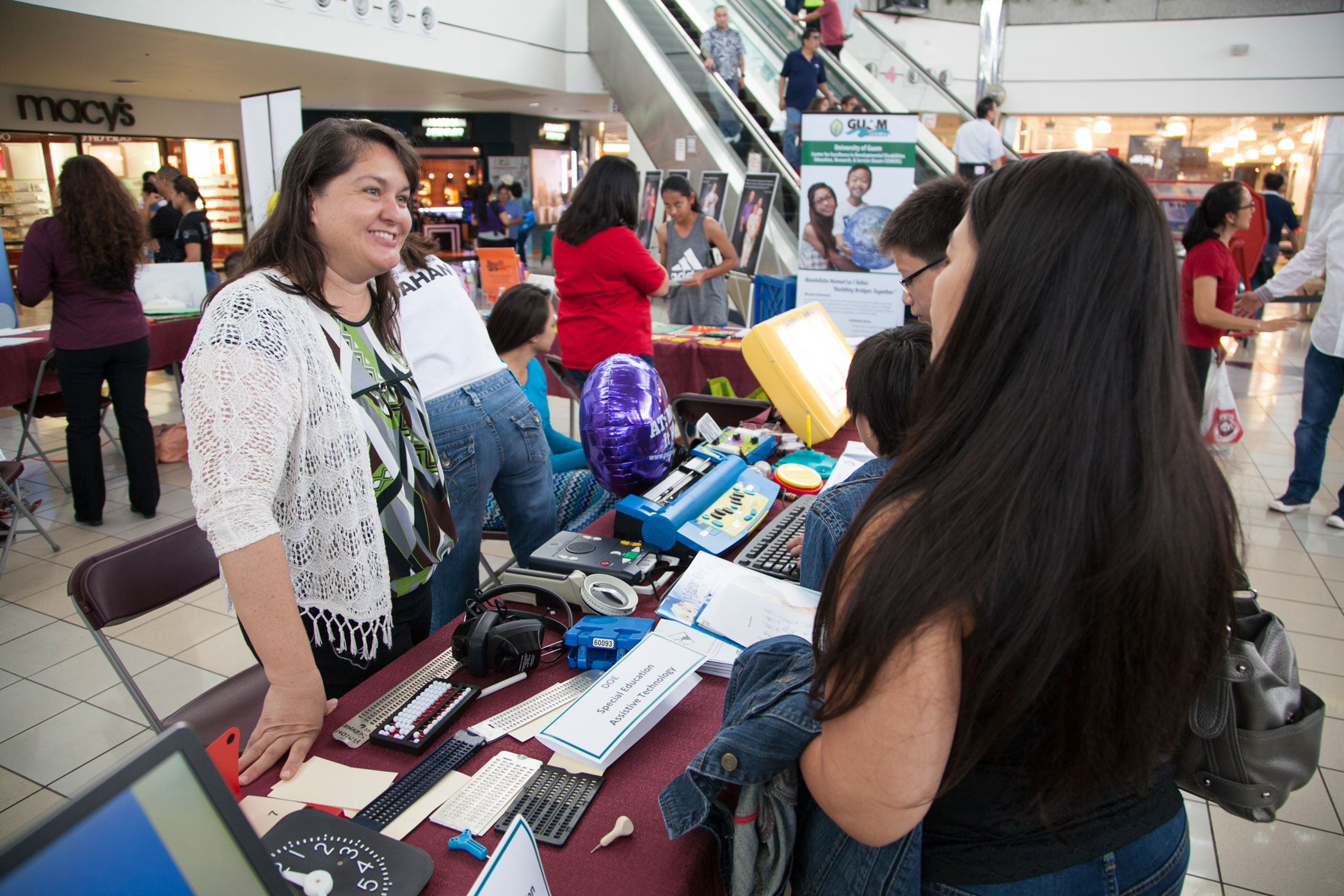 Photo of Diane Artero, Special Education Teachers, speaking with AT Fair attendees.
