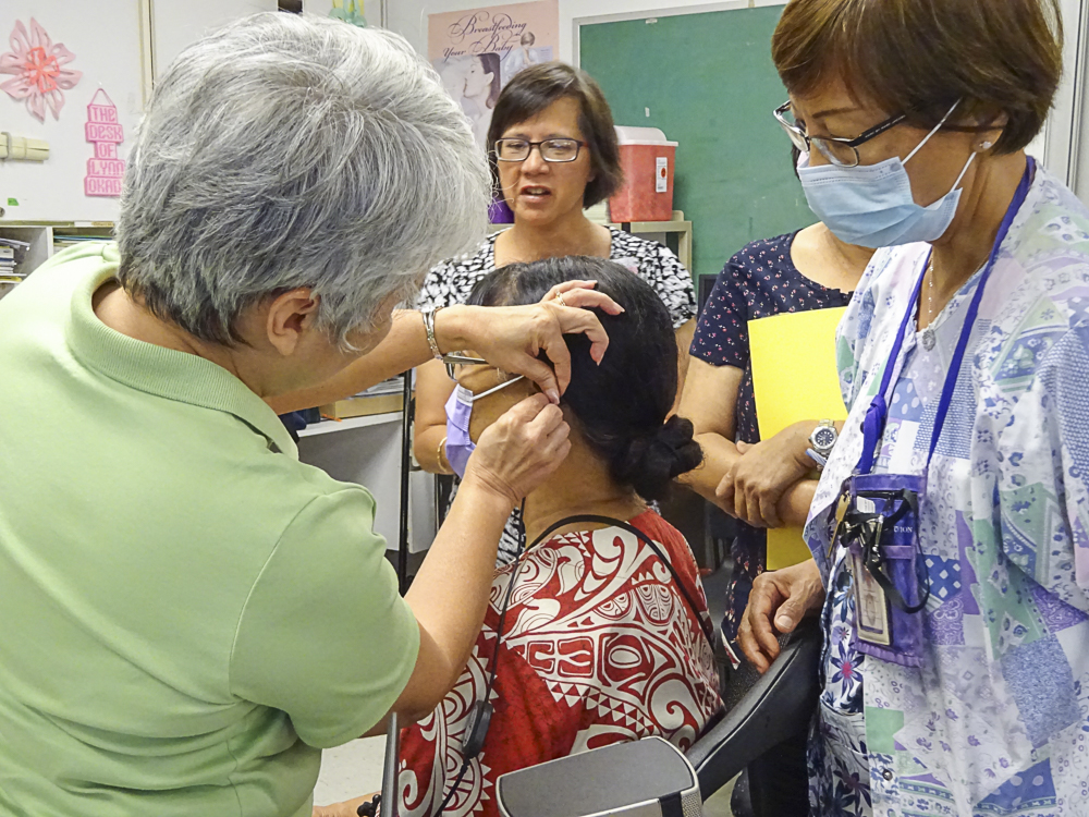 Marie Wusstig (Left), Guam CEDDERS Training Associate and Guam Early Hearing Detection & Intervention (EHDI) Project Coordinator, conducts hands-on training on the Bio-logic AuDx, Otoacoustic Emissions (OAE) equipment with Department of Public Health and Social Services (DPHSS) nurses in preparation for the upcoming High-Risk Hearing Rescreen Clinic for infants needing follow-up screening. The OAE training took place at DPHSS Central on Friday, August 11. 