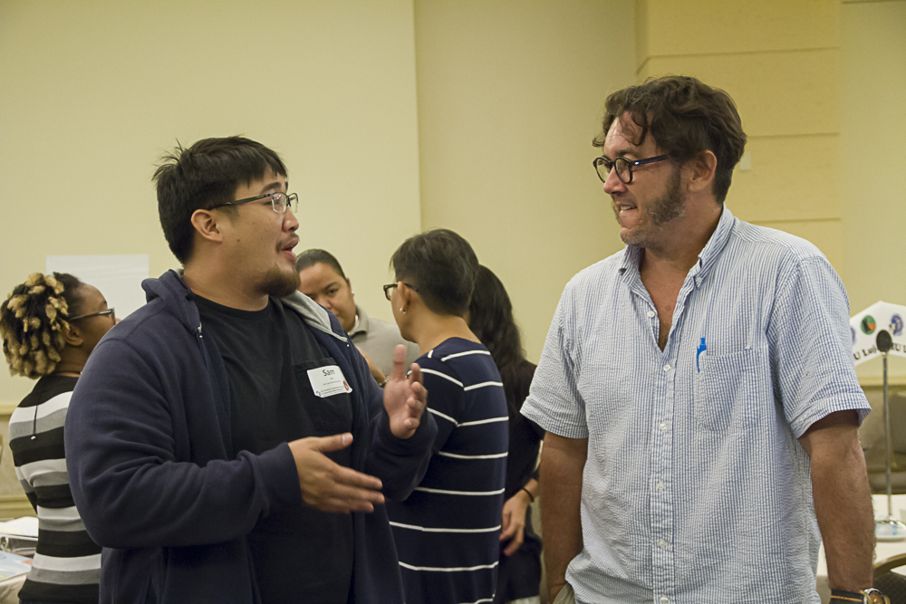 Two men talking to each other during the SSIP workshop.